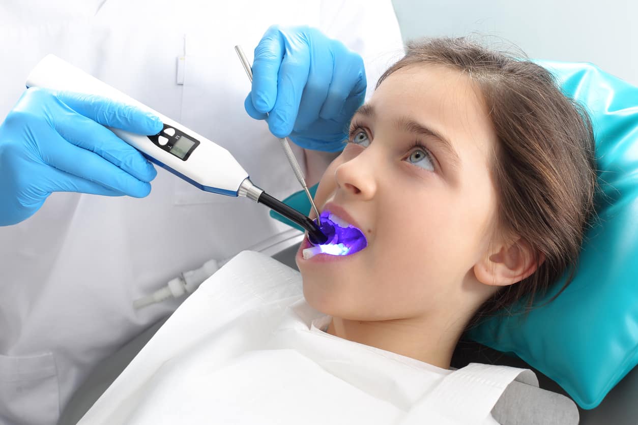 Child in the dental chair dental treatment during surgery.