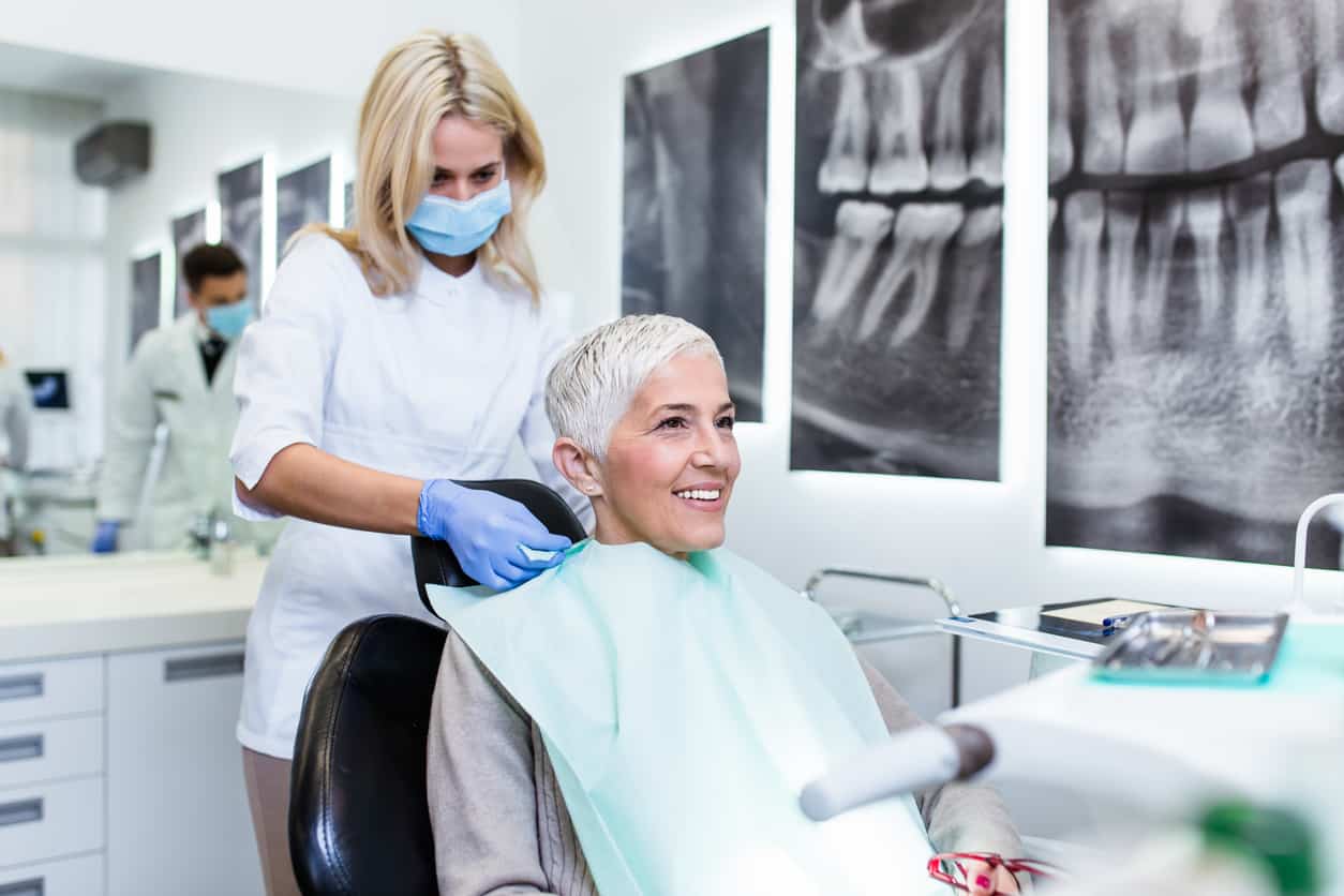 Beautiful senior woman receiving a dental treatment.