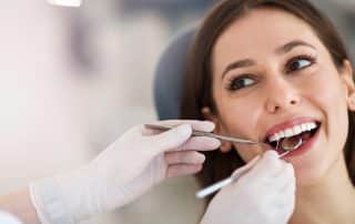 Woman having teeth examined at dentists