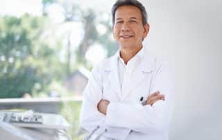 Dentist with arms crossed smiling