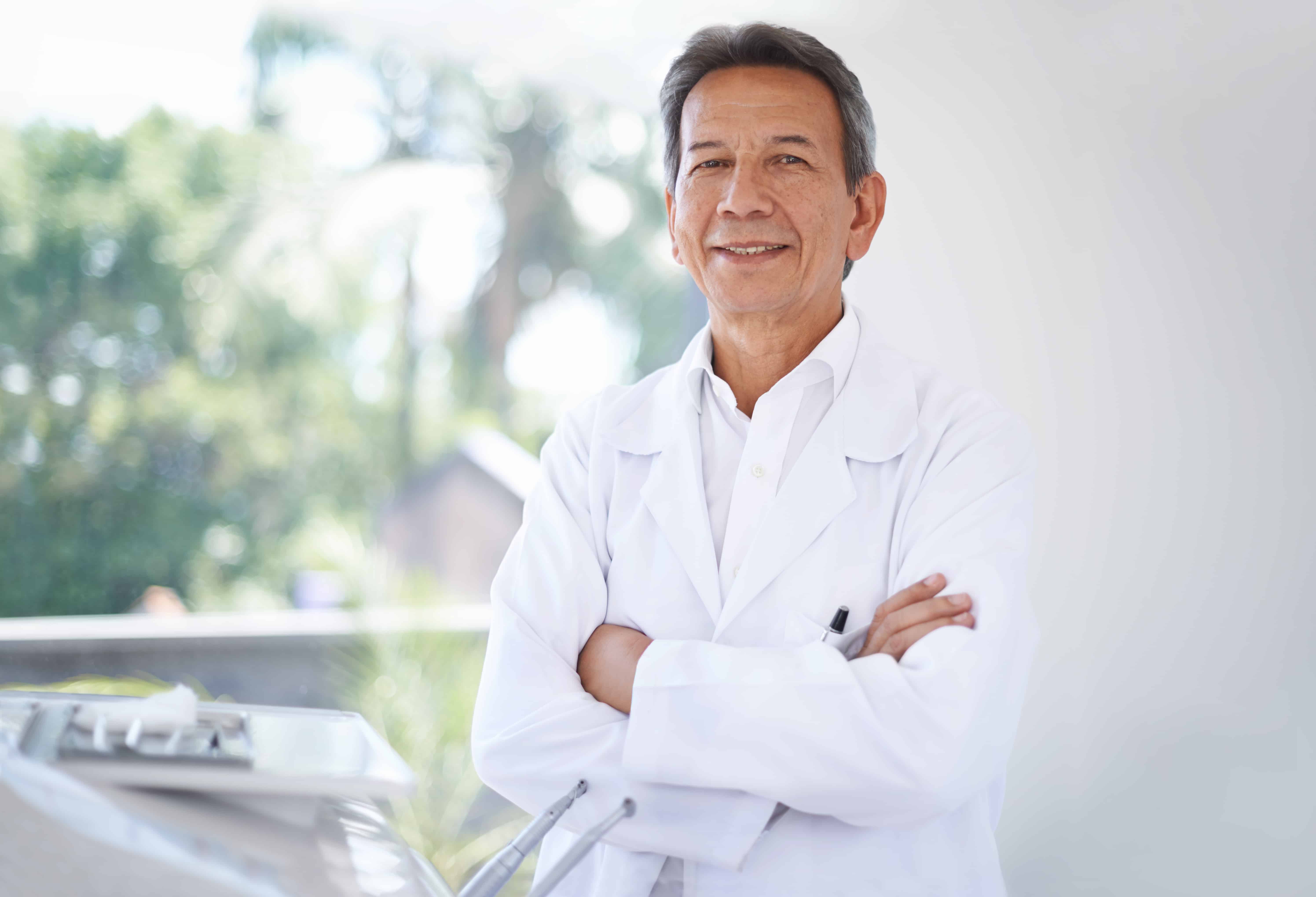Dentist with arms crossed smiling