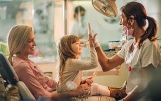 young child sitting in mothers lap at dentist office