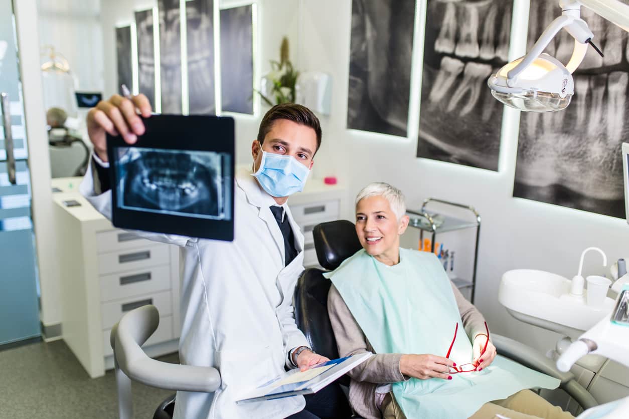 dentist showing woman dental xrays