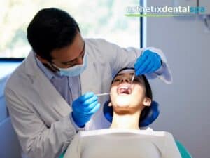 Dentist applying Fluoride Treatment during checkup