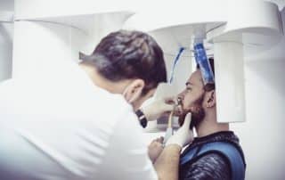 dentist screening patient for oral cancer