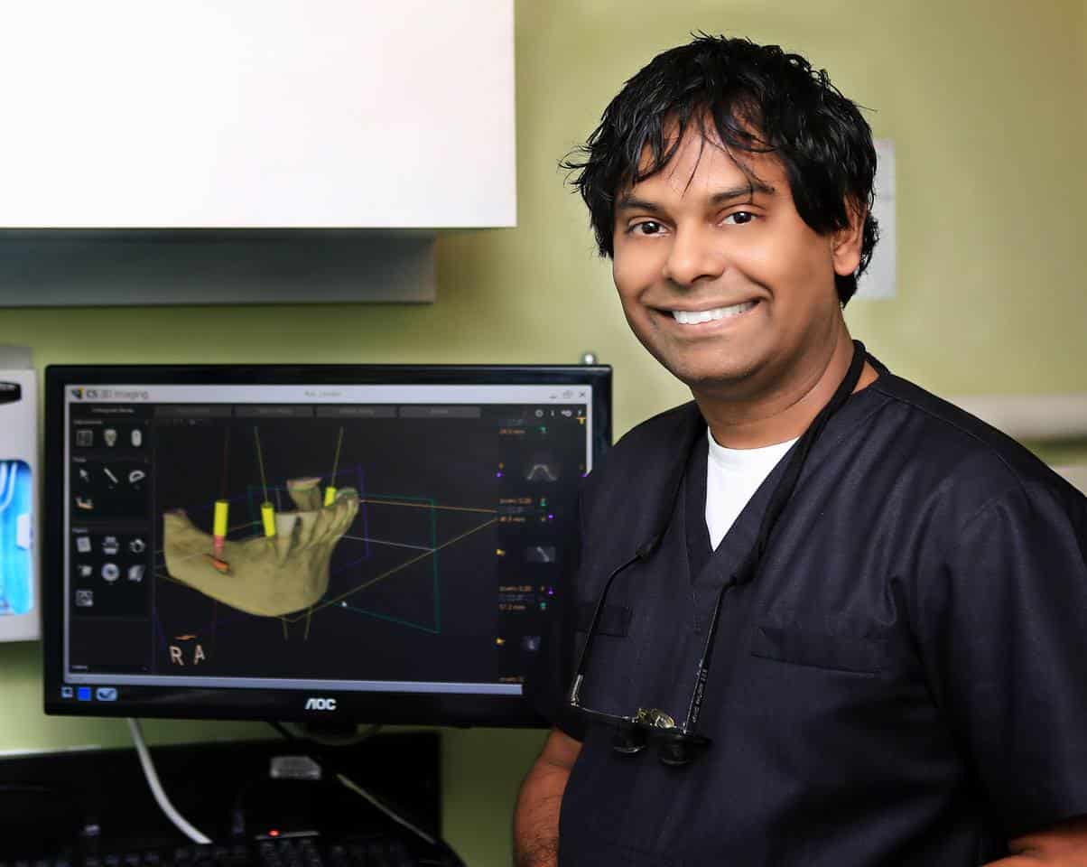 Dr. Arvind Piloming showing a Dental Procedure on the monitor