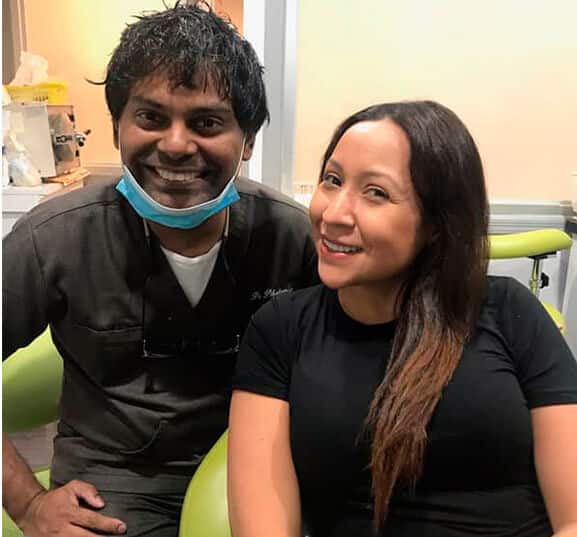 Dr. Philomin Next To A Patient At Esthetix Dental Spa